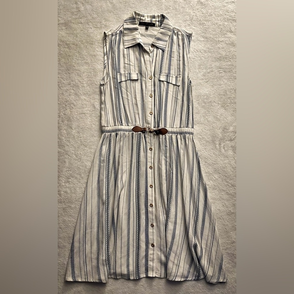 Medium length, collared, sleeveless summer dress.